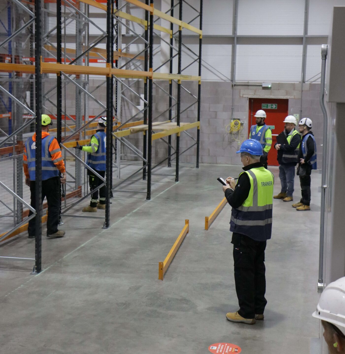 trainer guiding students on a warehouse training course